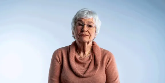 Older white woman looking straight at the camera
