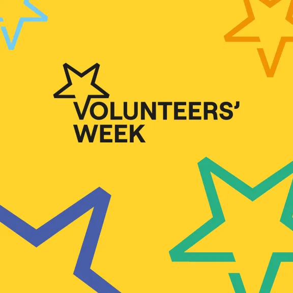 Black volunteers week logo on a yellow background surrounded by stars of various sizes